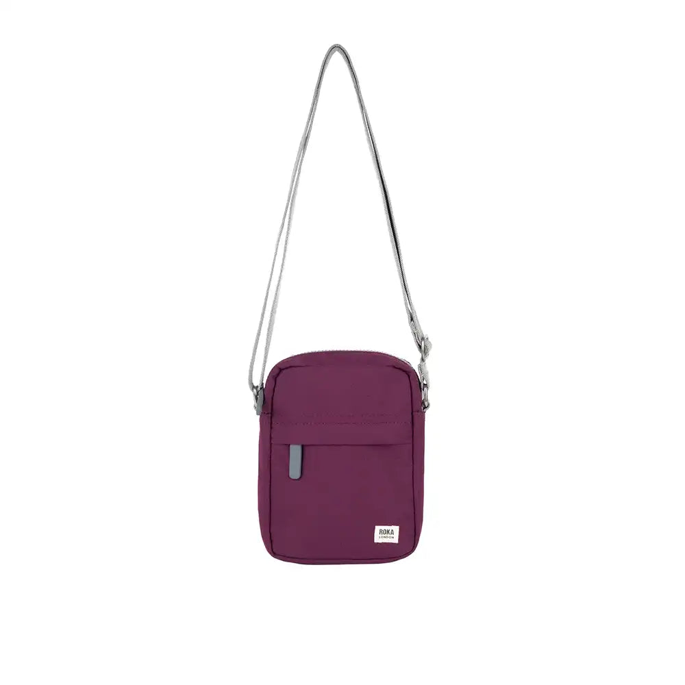 Purple crossbody bag with a strap on a white background
