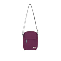 Purple crossbody bag with a strap on a white background