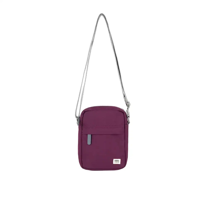Purple crossbody bag with a strap on a white background
