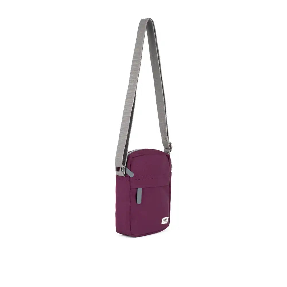 Purple crossbody bag with a gray strap on a white background