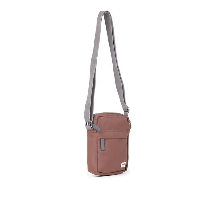 Brown crossbody bag with a gray strap on a white background