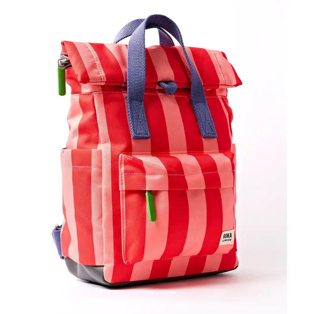 Side of pale pink and red stripey backpack with purple handle and lime green zip toggles. 