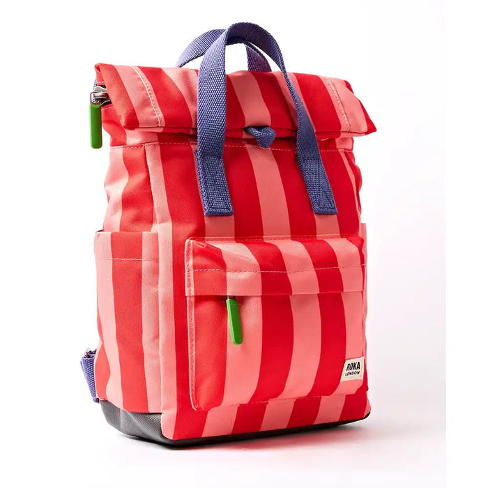 Side of pale pink and red stripey backpack with purple handle and lime green zip toggles. 