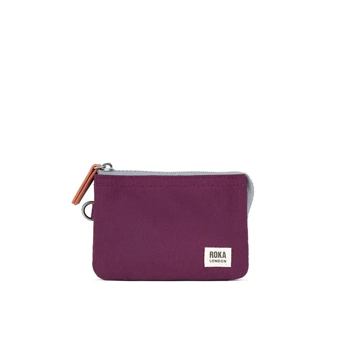 Purple pouch with a brown zipper on a white background, featuring the Roka London logo.