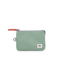 Green zippered pouch with 'ROKA London' label on a white background