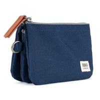 Blue pouch with brown zipper and Roka London tag on a white background