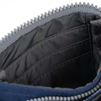 Close-up of a blue purse with a zipper, showing the interior.