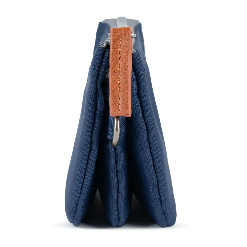 Blue fabric pouch with a brown leather tag on a white background