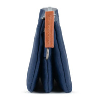 Blue fabric pouch with a brown leather tag on a white background