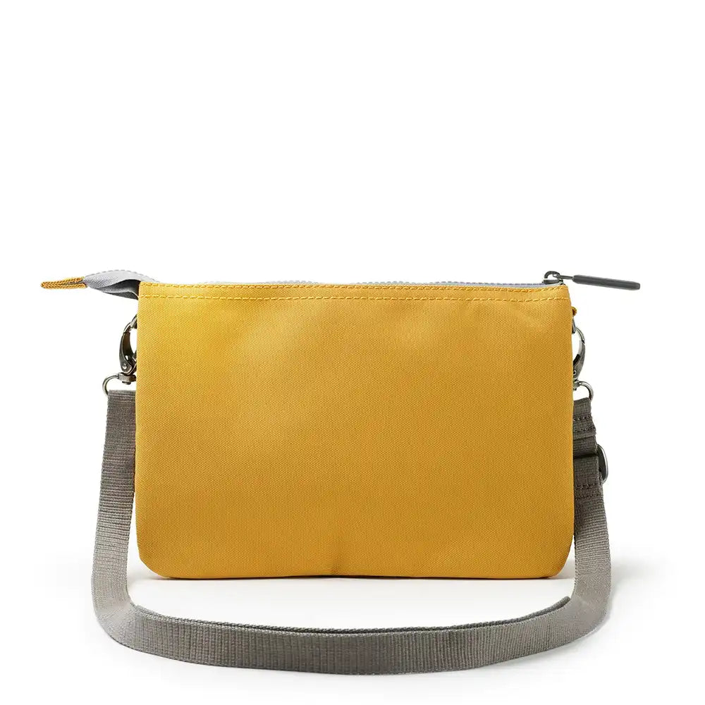 Yellow crossbody bag with a gray strap on a white background