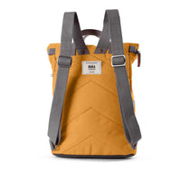 Rear view of a yellow backpack with padded chevron stitching and grey straps.ROKA label in white in middle. 