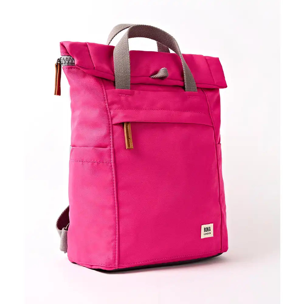 Side of a fuchsia coloured backpack with grey straps.