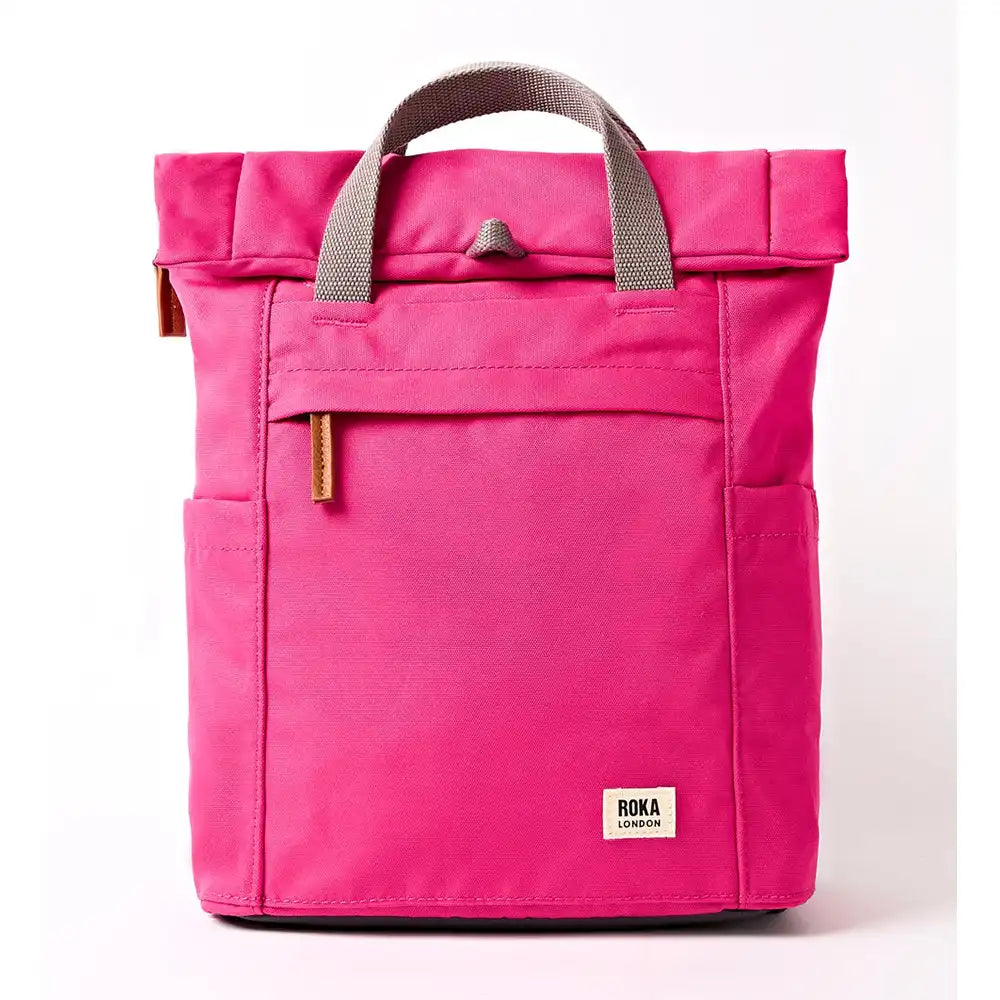 Front of a fuchsia coloured backpack with grey straps.