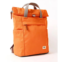 Side view of an Orange backpack with grey straps on a white background