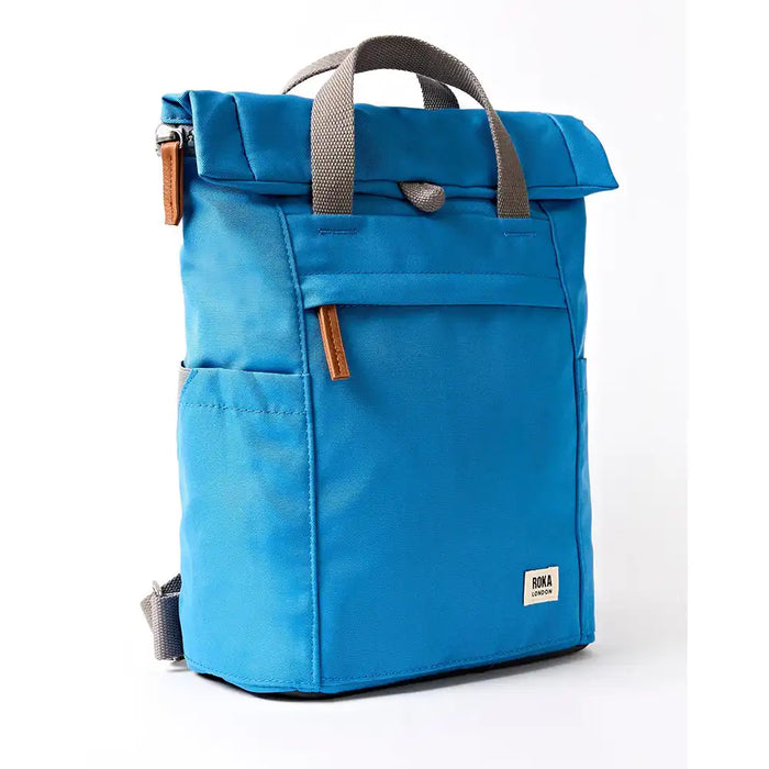 Angle of blue backpack with grey straps.