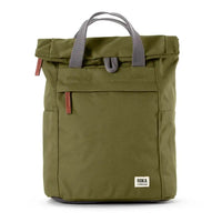 An olive green roll-top backpack with grey webbed handles, a front zip pocket, and a small white ROKA label on the lower right, shown against a plain white background.