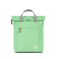 Roka pale green backpack with grey canvas straps and handles. Fold over zipped top opening. External zipped pocket. Open pockets on each side.