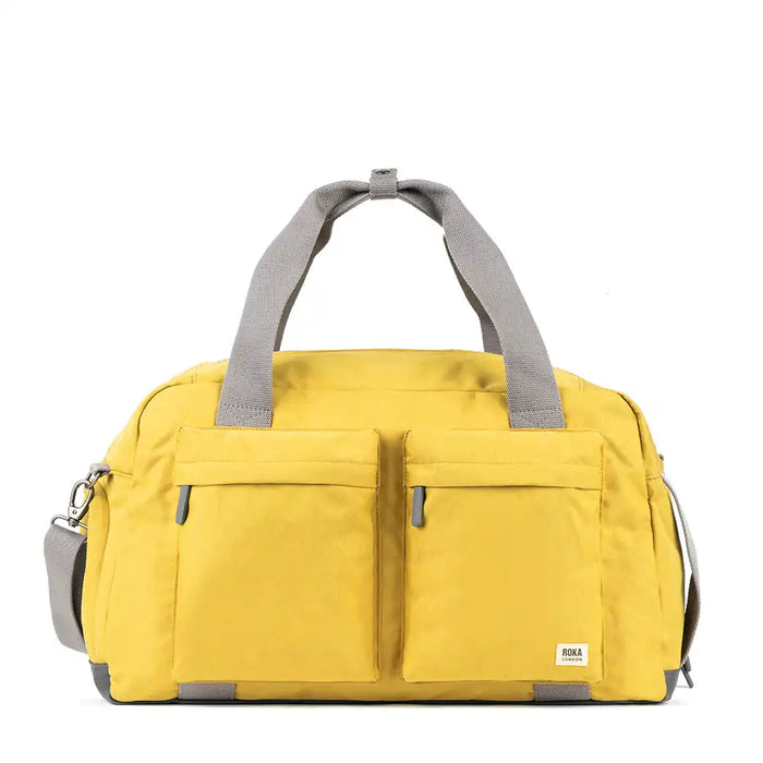 Yellow duffel bag with gray straps on a white background