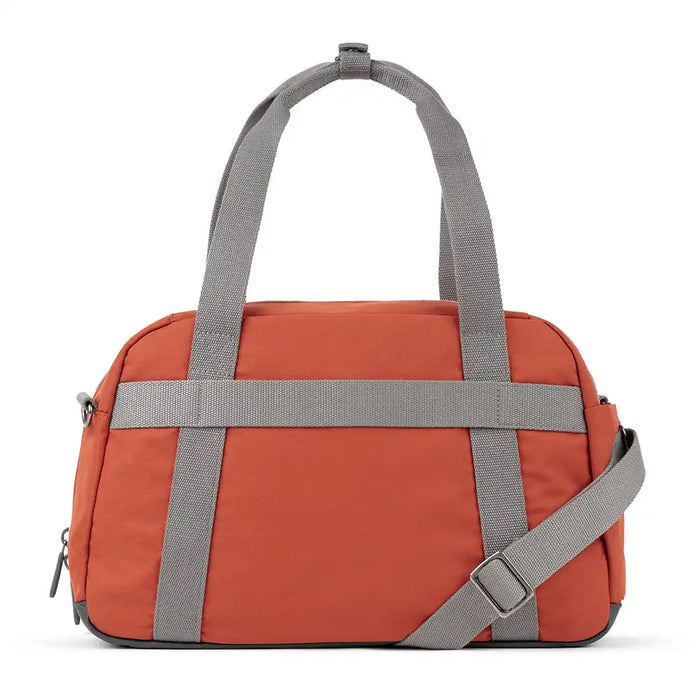 Orange duffel bag with gray straps on a white background