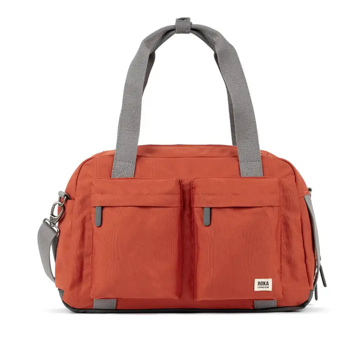 Orange duffel bag with gray straps on a white background
