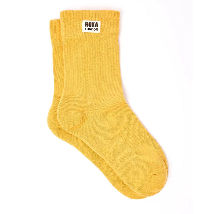 Crew style sock with 'Roka London' badge on the cuff. In a yellow colour.