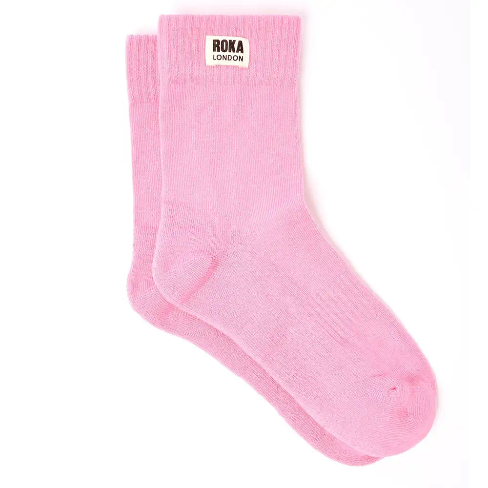 Crew style sock with 'Roka London' badge on the cuff. In a pale pink colour.