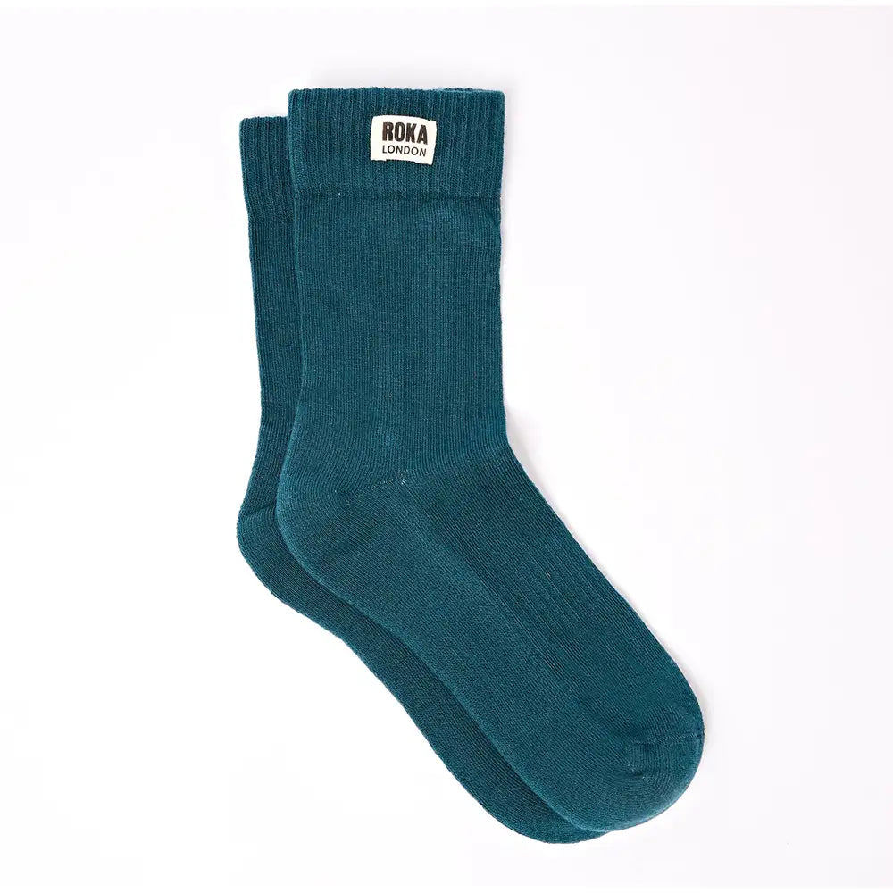 Crew style sock with 'Roka London' badge on the cuff. In a teal colour.