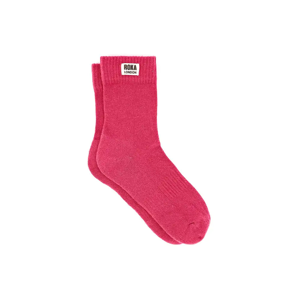 Red crew socks with a brand label on a white background