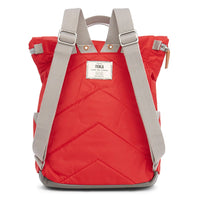 Rear view of a cranberry red backpack with padded chevron stitching and grey straps.ROKA label in white in middle. .