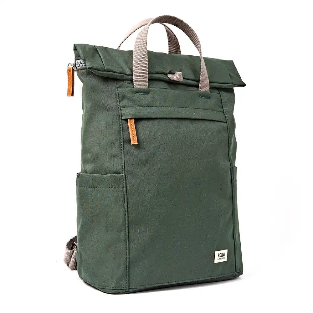 A dark olive green roll-top backpack with grey webbed handles and small brown zipper pulls, shown on a plain white background.