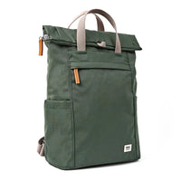 A dark olive green roll-top backpack with grey webbed handles and small brown zipper pulls, shown on a plain white background.