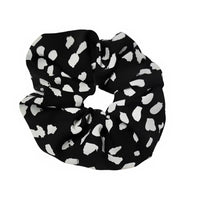 Black scrunchie with white heart pattern on a white background