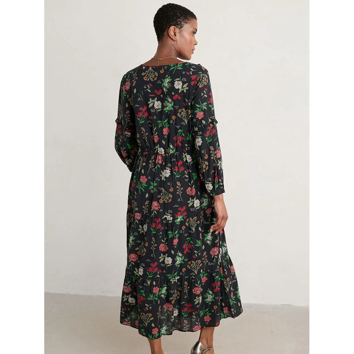 Seasalt Cornwall black dearling dress with floral, botanical pattern. V neck and calf length. Back view.