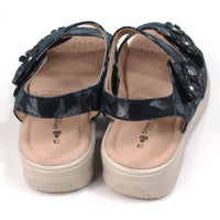 Shoe Tree Azalea navy sandals with floral pattern on fabric. Double straps across the feet fastened with Velcro. Straps around the ankles. Light tan, padded insoles. Low heels. Back view.