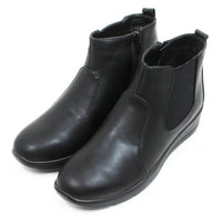 Shoe Tree black Chelsea style boots with low wedge heels. Zip fastening. Angled view.