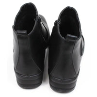 Shoe Tree black Chelsea style boots with low wedge heels. Zip fastening. Back view.