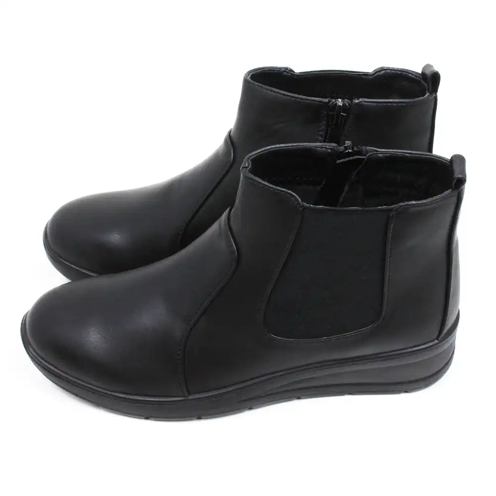 Shoe Tree black Chelsea style boots with low wedge heels. Zip fastening. Side view.