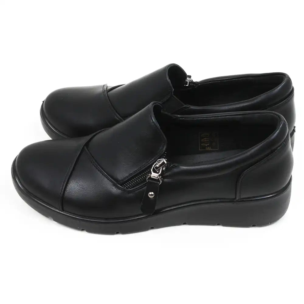 Black low heeled shoes with side short zips. Side view.