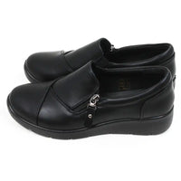Black low heeled shoes with side short zips. Side view.