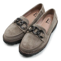 Pair of brown loafers with black chain details on a white background