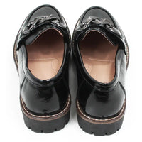 Pair of black patent faux leather loafers with a decorative buckle. Back view.