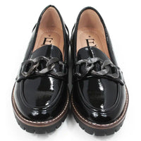 Pair of black patent faux leather loafers with a decorative buckle. Front view.