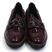 Shoes by Emma patent burgundy loafers with black chunky soles. Over the toes grey metal chain detail. Front view.