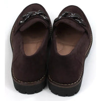 Pair of brown loafers with black decorative accents on a white background. Back view.