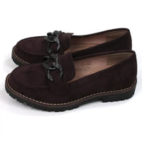 Pair of brown loafers with black decorative accents on a white background. Side view.