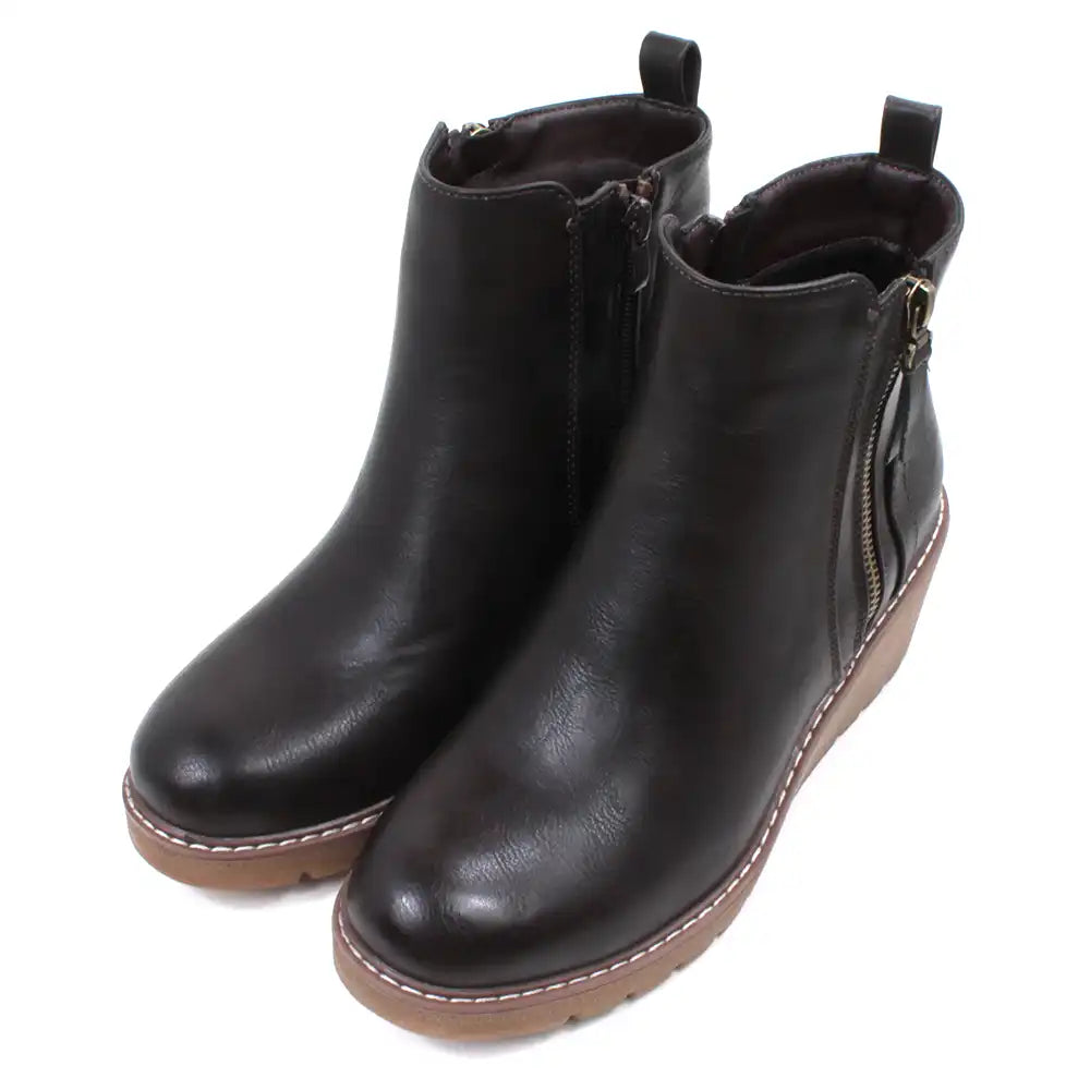 Dark brown Chelsea style ankle boots with light brown wedge soles and heels.