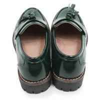 A pair of dark green patent leather tassel loafers shown from a top-down view on a white background.