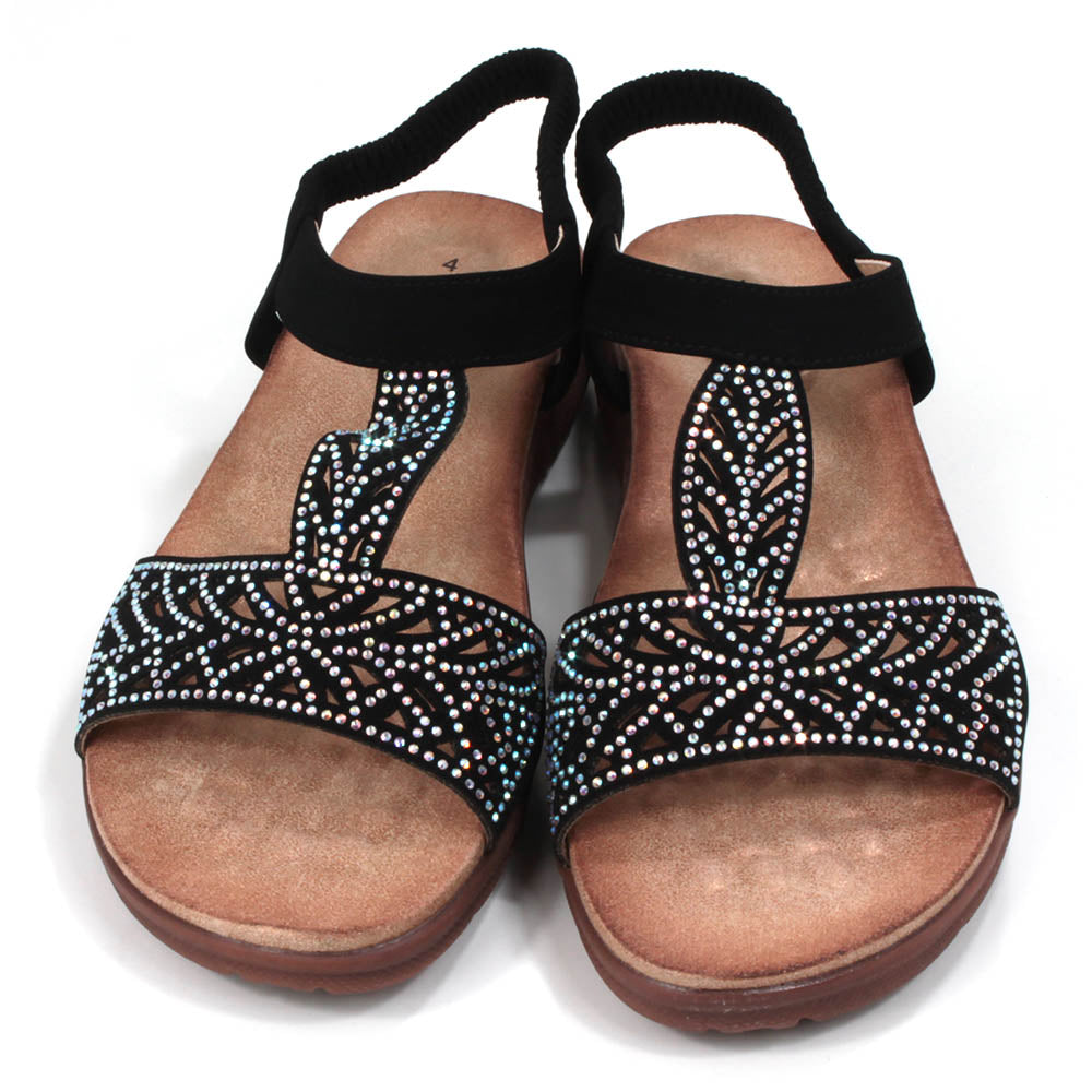 Black sandals decorated with diamantes. Elasticated black ankle strap. Tan, molded insoles. Front view.