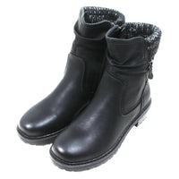 Black leather look ankle boots with grey and white knitted ankle cuffs. Low heels. Angled view.