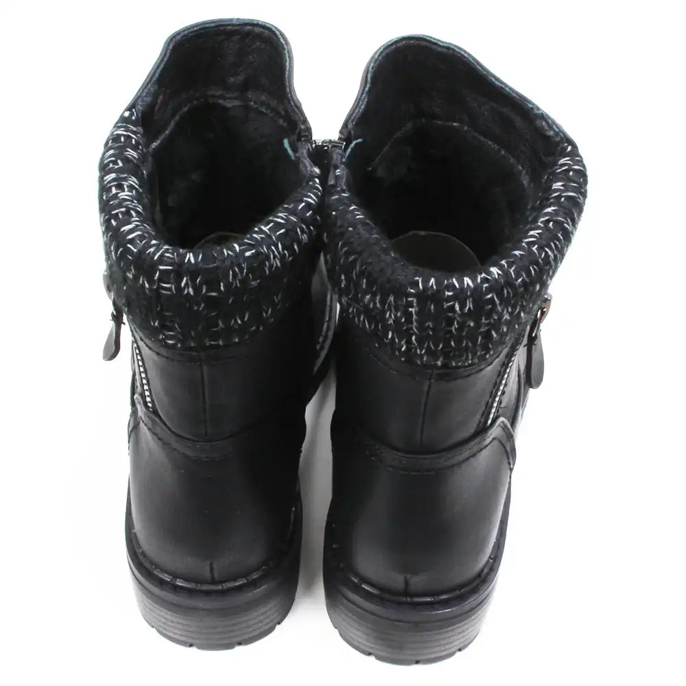 Black leather look ankle boots with grey and white knitted ankle cuffs. Low heels. Back view.